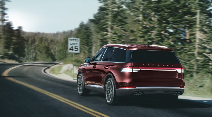 A 2024 Lincoln Aviator® SUV is being driven on a winding mountain road | Dave Sinclair Lincoln St. Peters in Saint Peters MO