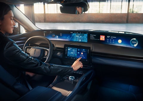 The driver of a 2024 Lincoln Nautilus® SUV interacts with the center touchscreen. | Dave Sinclair Lincoln St. Peters in Saint Peters MO